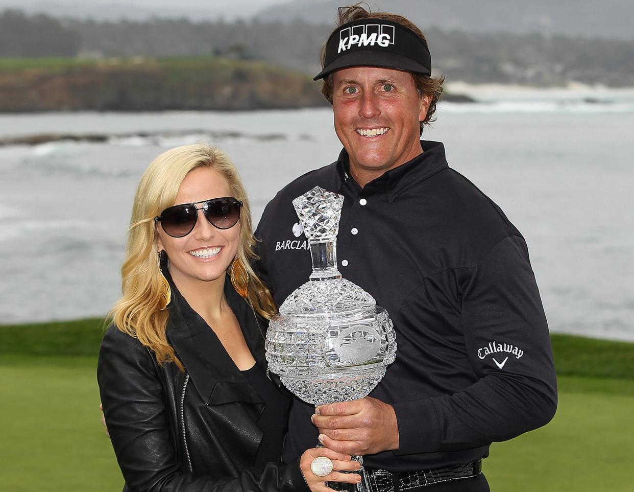 Phil Mickelson (R) celebrates with his wife Amy (L) while holding the tournament trophy after winning with an eight-under-par 64 during the AT&amp;T Pebble Beach National Pro-Am at Pebble Beach Golf Links on February 12, 2012 in Pebble Beach, California