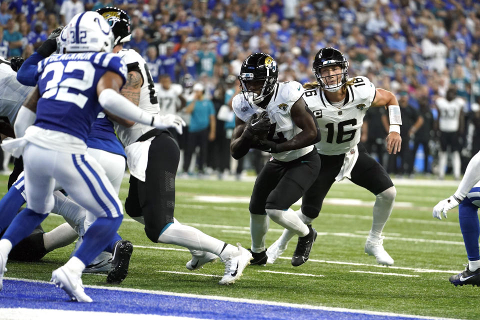 Jacksonville Jaguars running back Tank Bigsby (4) scores on a 1-yard run as Jaguars quarterback Trevor Lawrence (16) watches during the second half of an NFL football game against the Indianapolis Colts Sunday, Sept. 10, 2023, in Indianapolis. (AP Photo/Darron Cummings)