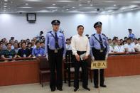 Bo Xilai stands in the Jinan Intermediate People's Court as his corruption verdict is read out, on September 22, 2013