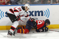 SUNRISE, FL - APRIL 21: Bryce Salvador #24 of the New Jersey Devils checks Scottie Upshall #19 of the Florida Panthers off the puck in Game Five of the Eastern Conference Quarterfinals during the 2012 NHL Stanley Cup Playoffs at the BankAtlantic Center on April 21, 2012 in Sunrise, Florida. The Panthers defeated the Devils 3-0. (Photo by Joel Auerbach/Getty Images)