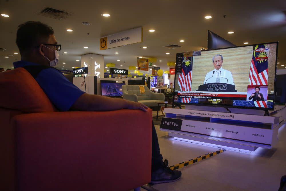 A man watches a live telecast of Prime Minister Tan Sri Muhyiddin Yassin’s speech in Kuala Lumpur September 23, 2020. ― Picture by Yusof Mat Isa