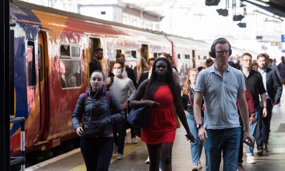 <span>Commuters arrive at Waterloo station during the morning rush hour. The number of rail journeys made by passengers using season tickets fell to 13% in the year to 31 March, from 15% in the previous year.</span><span>Photograph: Anadolu Agency/Getty Images</span>