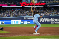 Toronto Blue Jays' Vladimir Guerrero Jr. (27) is safe as Washington Nationals first baseman Dominic Smith attempts to make a catch during sixth-inning baseball game action in Toronto, Monday, Aug. 28, 2023. (Andrew Lahodynskyj/The Canadian Press via AP)