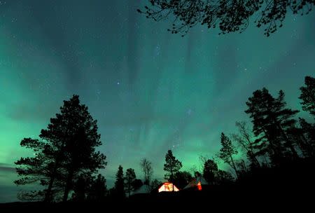 FILE PHOTO: The Aurora Borealis (Northern Lights) is seen over a mountain camp north of the Arctic Circle, near the village of Mestervik, Norway September 30, 2014.REUTERS/Yannis Behrakis/File Photo