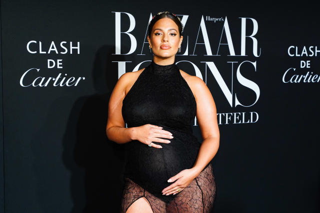 Ashley Graham changes her newborn son's diaper on the floor of