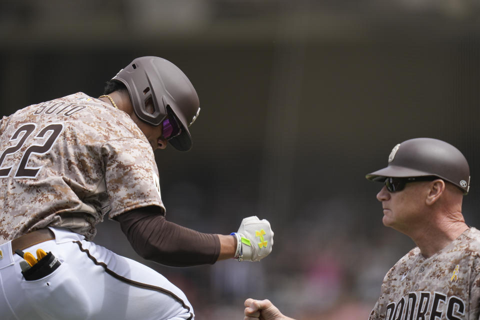 San Diego Padres' Juan Soto, left, celebrates with third base coach Matt Williams after hitting a two-run home run during the first inning of a baseball game against the San Francisco Giants, Sunday, Sept. 3, 2023, in San Diego. (AP Photo/Gregory Bull)