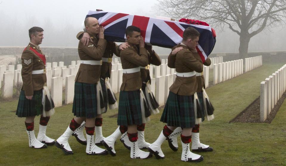 Military pallbearers carry the casket of British World War One soldier William McAleer during a reburial service at the Loos British World War One cemetery in Loos-en-Gohelle, France on Friday, March 14, 2014. Private William McAleer, of the 7th Battalion, Royal Scots Fusiliers, was killed in action on Sept. 26, 1915 during the Battle of Loos. His body was found and identified in 2010 during routine construction in the area and is being reburied with full military honors along with 19 unknown soldiers. (AP Photo/Virginia Mayo)