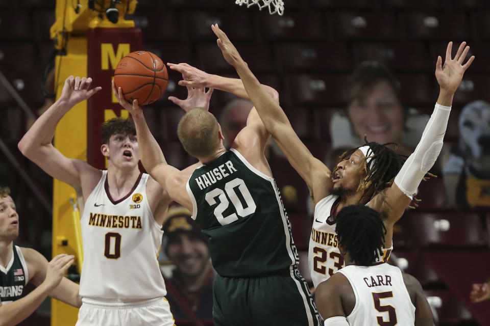 Minnesota's Brandon Johnson (23) fouls Michigan State's Joey Hauser (20) during the first half of an NCAA college basketball game Monday, Dec. 28, 2020, in Minneapolis. (AP Photo/Stacy Bengs)