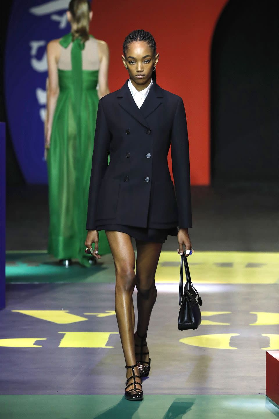 <p>Maria Grazia Chiuri delved back into the extensive Dior archives for Spring 22, and to Marc Bohan’s long tenure with the storied house. Zeroing in even further, Chiuri turns to the Slim Look collection,<br>presented in 1961. At the time of its release, the press said “It completely changes fashion, just as the New Look did in 1947." In other words, it was a moment. The show took place on a graphic, color-blocked set conceived by artist Anna Paparatti<em>.</em> The looks themselves followed that colorful spirit —leveraging yellow, green, red, navy, orange, and raspberry on little skirt suits, along fun, fringe dresses inspired by the iconic Roman nightclub the Piper Club. There is also a range of bright, boxing inspired looks, bold prints, like that found on a silk maxi skirt paired with a sheer black blouse, and louche denim suiting. Overall, the collection is inspired by...nonsense? As the show notes explain, Grazia Chiuri looked to Anna Paparatti’s Il Gioco del Nonsense (The Game of Nonsense). Nonsense, as the American poet and literary critic Susan Stewart saw it, is “perfect, pure, an untouched surface of meaning whose every gesture is reflexive." Maybe something a little like boxing? -<em>Kerry Pieri</em><br><br></p>