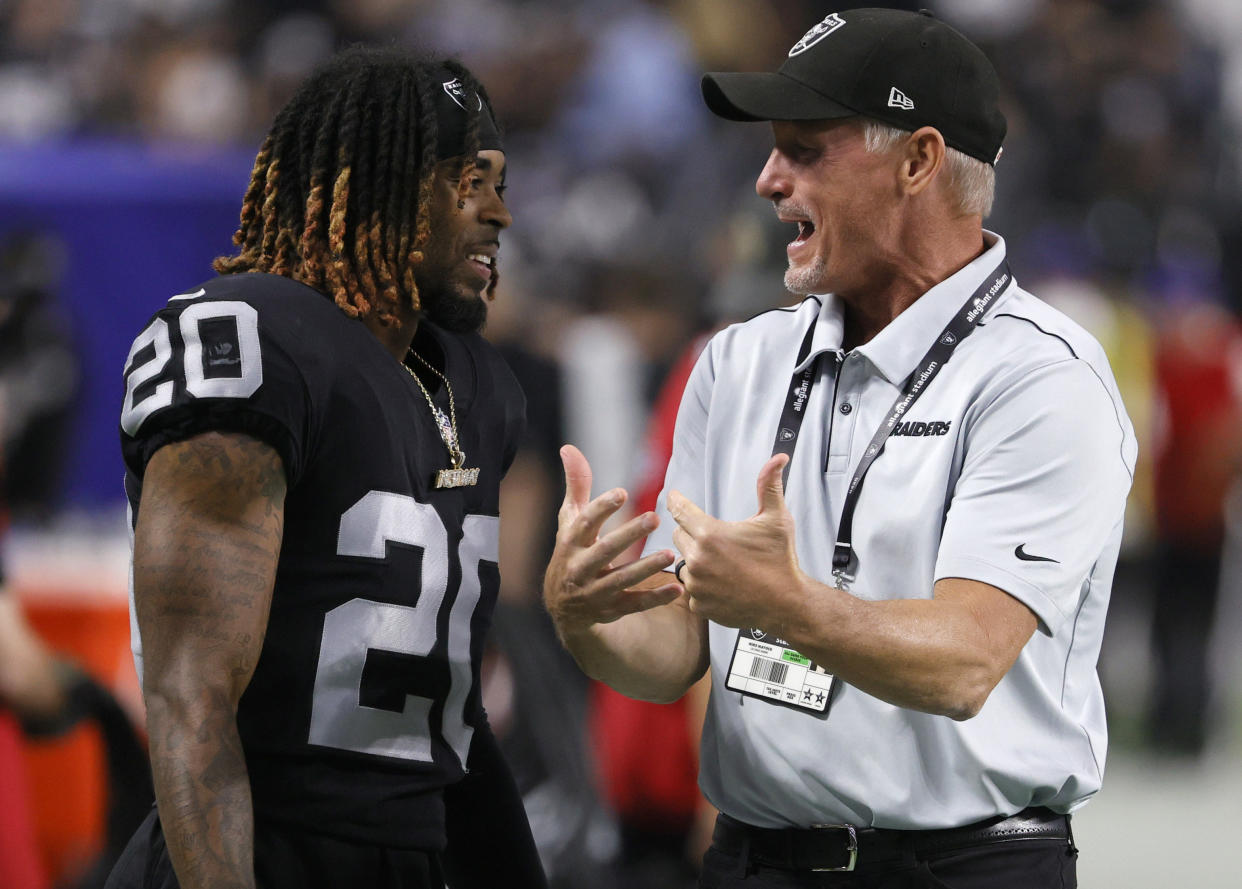 LAS VEGAS, NEVADA - AUGUST 14:  Cornerback Damon Arnette #20 of the Las Vegas Raiders talks with general manager Mike Mayock after the team's 20-7 victory over the Seattle Seahawks in a preseason game at Allegiant Stadium on August 14, 2021 in Las Vegas, Nevada.  (Photo by Ethan Miller/Getty Images)