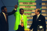 Brazilian superstar Pele (l) raises the arm of Abedi Pele (centre) during the last ever World Cup Qualifying Draw for the Conmebol region, held in New York, USA. General Secretary Sepp Blatter (r) looks on. (Photo by Ross Kinnaird/EMPICS via Getty Images)