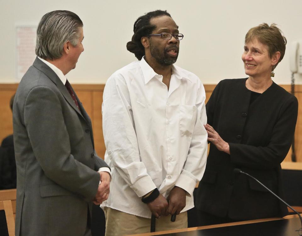 Robert Hill, center, stands with his lawyers Harold Ferguson, left, and Sharon Katz, right, as Justice Neil Firetog declared him exonerated in Brooklyn Supreme Court, Tuesday May 6, 2014 in New York. Prosecutors in Brooklyn asked to throw out the decades-old convictions of three half-brothers who were investigated by homicide detective Louis Scarcella, whose tactics have come into question. The defendants, Hill, Alvena Jennette and Darryl Austin became the first people connected to the detective to be exonerated. (AP Photo/Bebeto Matthews)