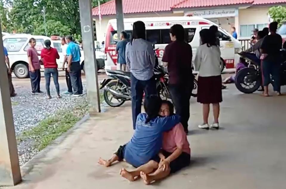 In an image taken from video, a distraught woman is comforted outside the site of the attack (AP)