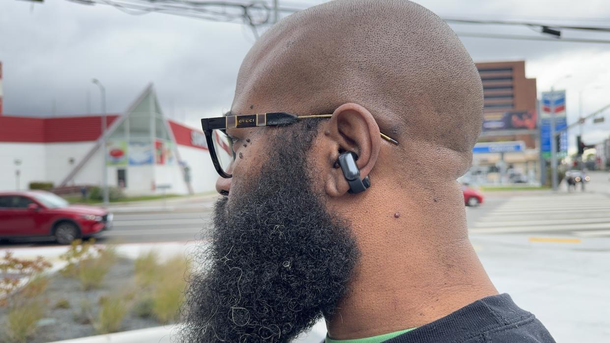  Bose Ultra Open Earbuds being used in an urban environment. 