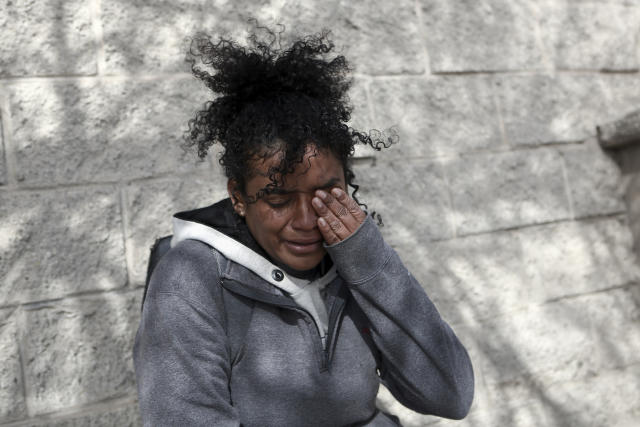 A Venezuelan migrant woman cries in front at of a Mexican immigration detention center in Ciudad Juarez, Mexico, Tuesday, March 28, 2023, where a fire in a dormitory left more than three dozen migrants dead. President Andrés Manuel López Obrador said the fire was started by migrants in protest after learning they would be deported. (AP Photo/Christian Chavez)
