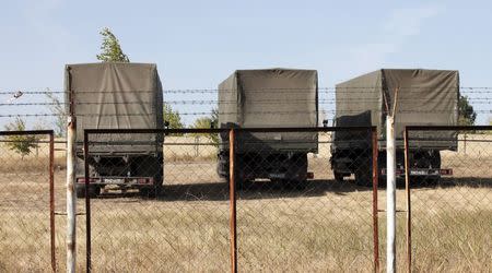 Russian military trucks are seen on the territory of an old military depot near the Russian-Ukrainian border in the town of Boguchar, south of Voronezh, Russia, September 21, 2015. REUTERS/Anton Zverev