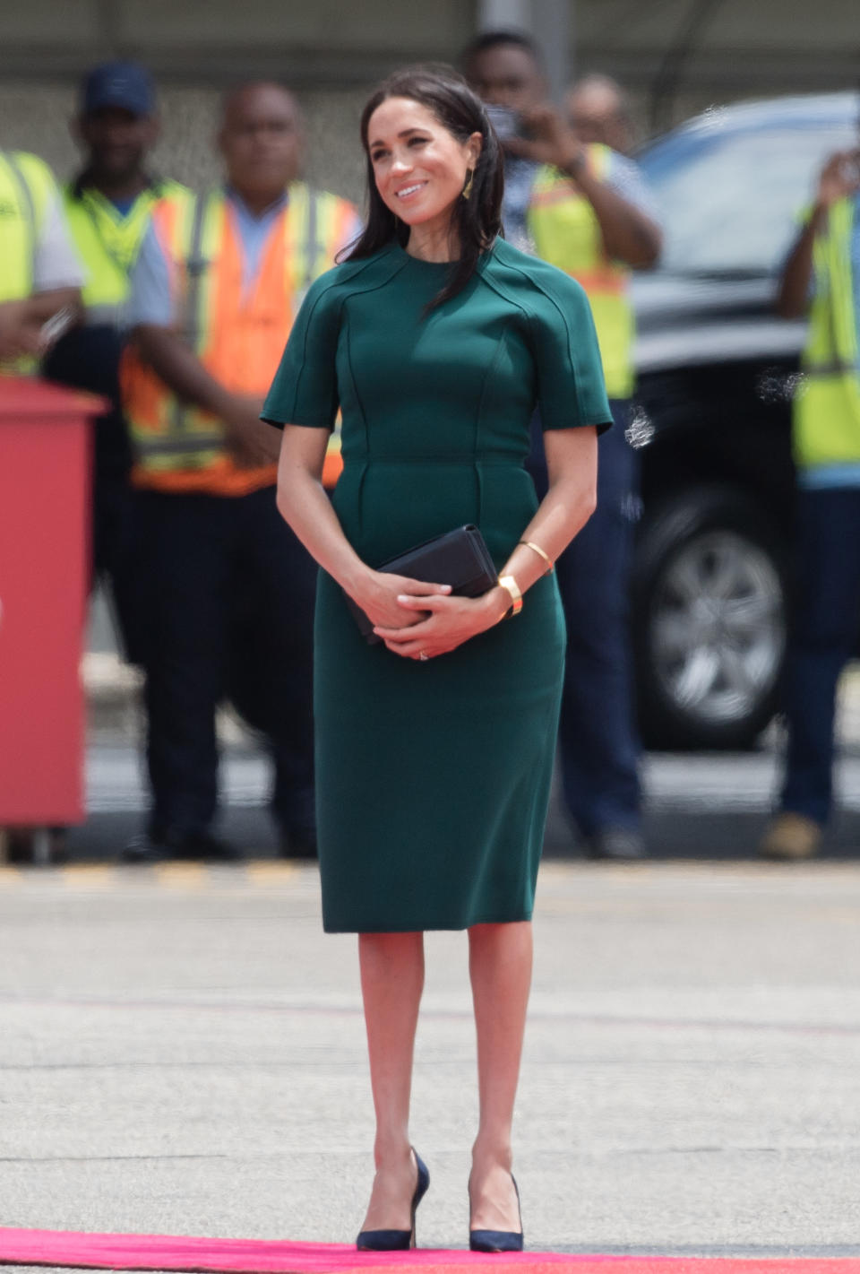 <p>The Duchess of Sussex touched down in Fiji wearing a forest green Jason Wu dress with navy £484 Manolo Blahnik shoes to finish. [Photo: Getty] </p>