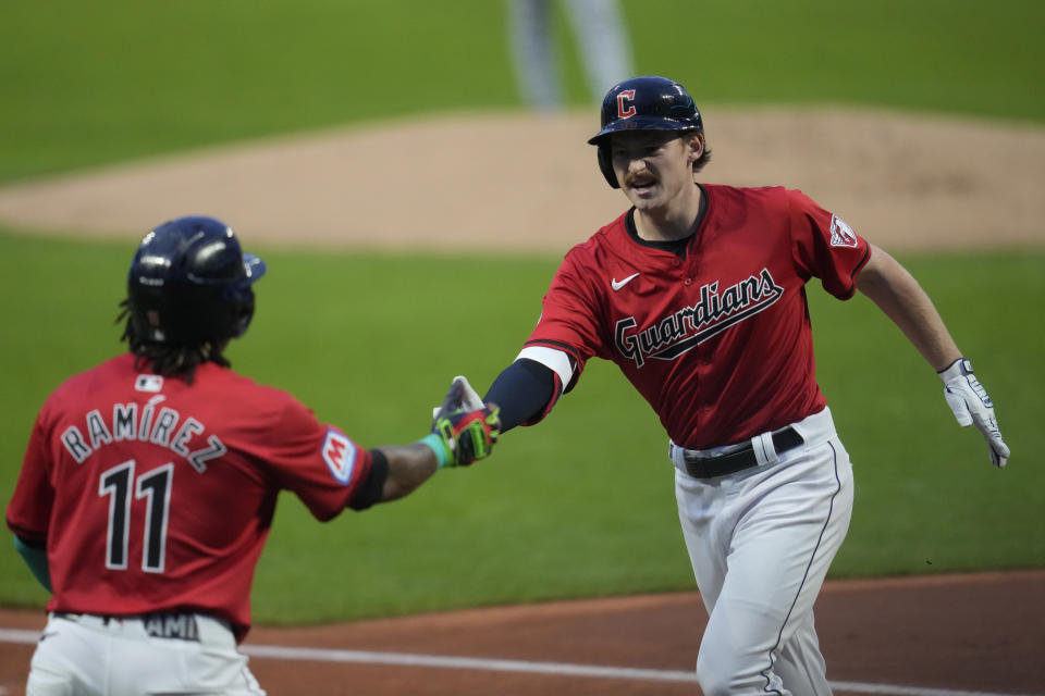 Cleveland Guardians' Kyle Manzardo, right, is congratulated by teammate Jose Ramirez (11) after his home run in the first inning of a baseball game against the Cincinnati Reds in Cleveland, Tuesday, Sept. 24, 2024. (AP Photo/Sue Ogrocki)