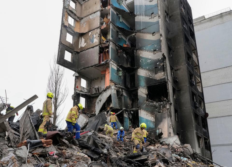 Emergency workers shift the rubble from a multi-storey building destroyed in a Russian attack, at the beginning of the Russia-Ukraine war in Borodyanka, close to Kyiv, Ukraine, Saturday, April 9, 2022.  AP Photo/Efrem Lukatsky