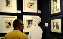 A potential bidder looks at Marylin Monroe photos prior to an auction of pictures by the late celebrity photographer Milton H. Greene, in Warsaw, Poland, Thursday, Nov. 8, 2012. (AP Photo/Alik Keplicz)