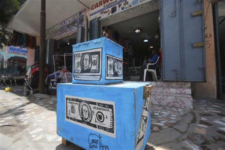 A stall decorated with pictures of U.S dollar notes, which is used as a money exchange booth, is seen in the Hamaerweyne area of Mogadishu September 30, 2013. REUTERS/Feisal Omar