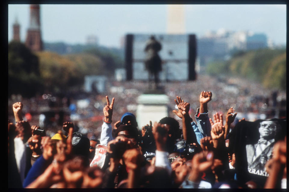 Attendees at the Million Man March raise their hands in fists and peace/victory signs October 16, 1995 in Washington, DC. The purpose of the march was to galvanize men to respect themselves and others spiritually, morally, mentally, socially, politically and economically. 