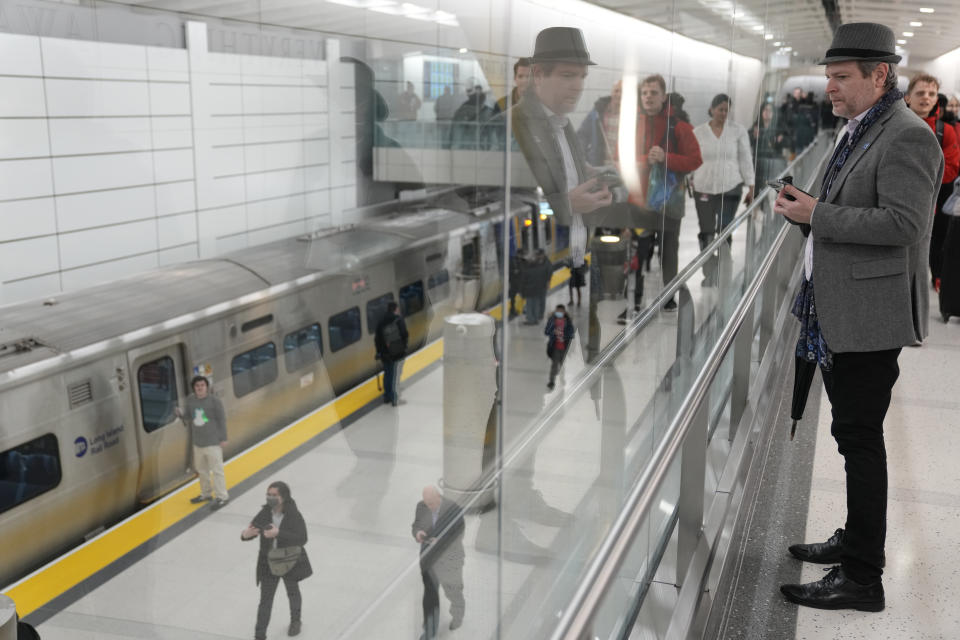 People look around the new platform after the first Long Island Railroad train arrived in a new annex to Grand Central Station in New York, Wednesday, Jan. 25, 2023. After years of delays and massive cost overruns, one of the world's most expensive railway projects on Wednesday began shuttling its first passengers between Long Island to a new annex to New York City's iconic Grand Central Terminal. (AP Photo/Seth Wenig)