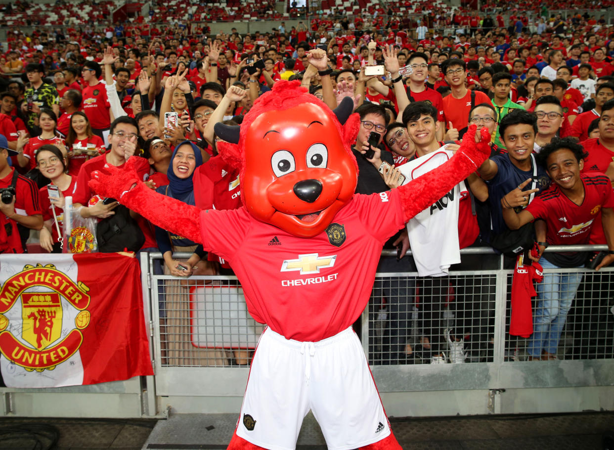 Manchester United fans in Singapore show their support with club mascot Fred the Red during the 2019 International Champions Cup in Singapore.