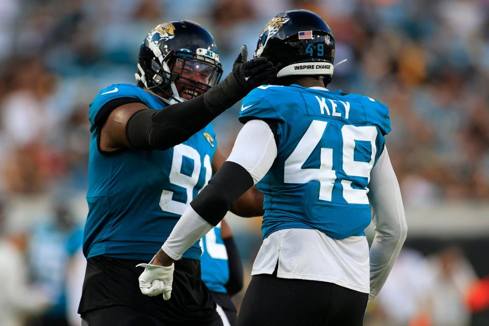 Jacksonville Jaguars defensive end Dawuane Smoot #91 congratulates defensive end Arden Key #49 on his sack during the first quarter of an NFL preseason game Saturday, Aug. 20, 2022 at TIAA Bank Field in Jacksonville. [Corey Perrine/Florida Times-Union]