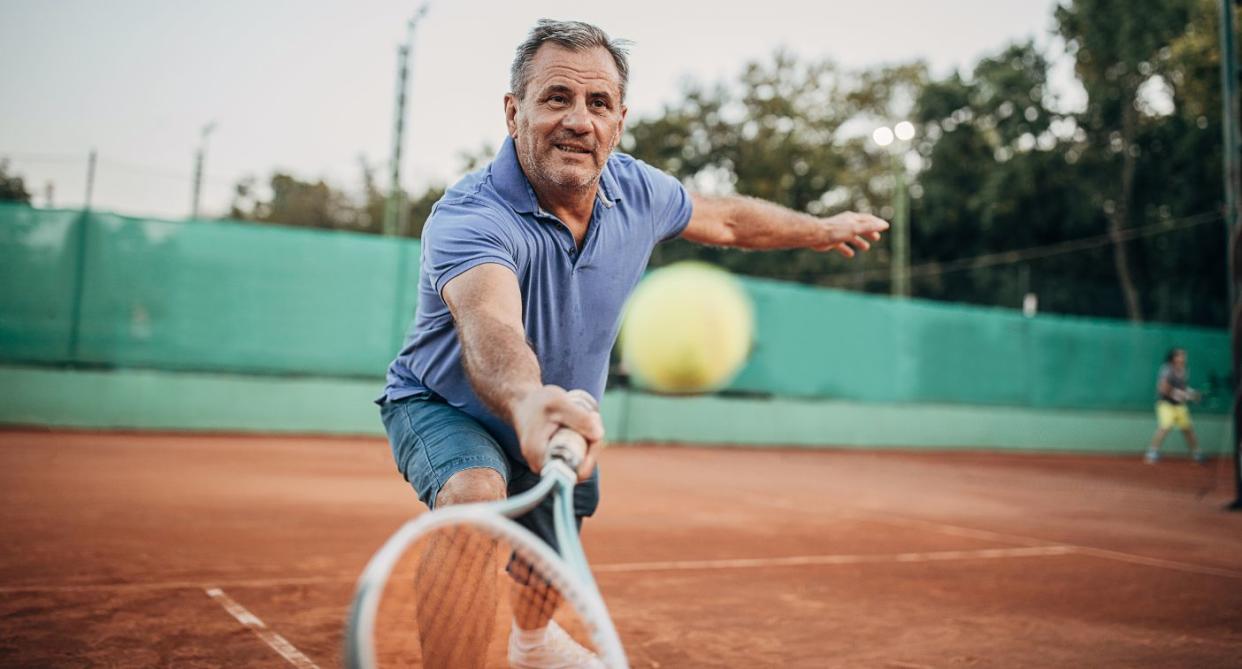 Man playing tennis. (Getty Images)