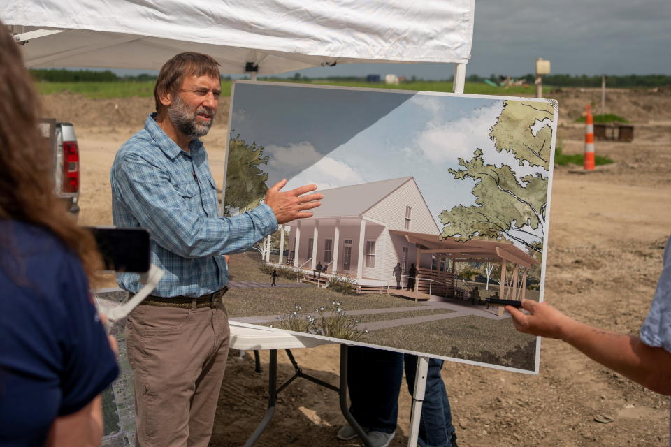 A man shows an artistic rendering of a proposed structure.