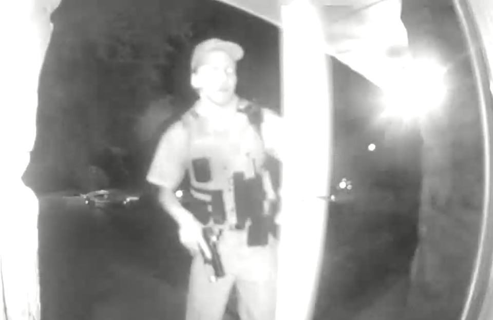 A still from a doorbell camera video shows an officer with his weapon drawn as he's about to enter a Fayetteville home where a woman was shot and killed by police last week.