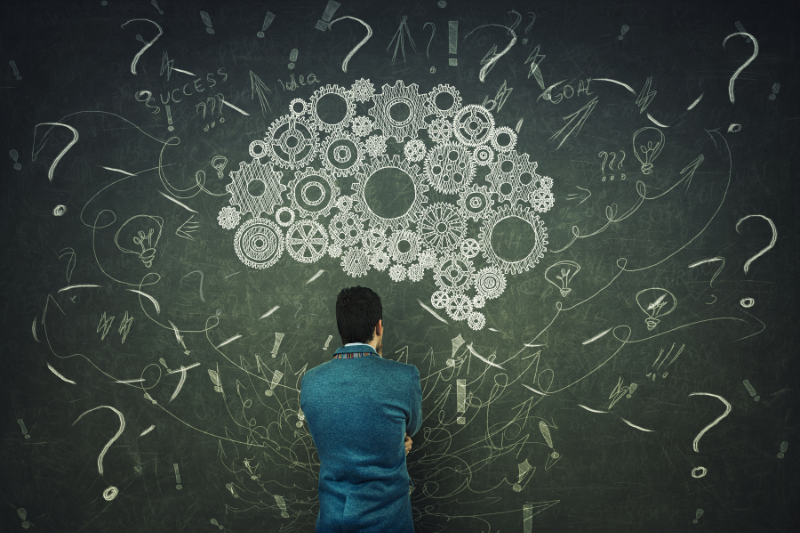 Man Looking at Brain Made up of Gears