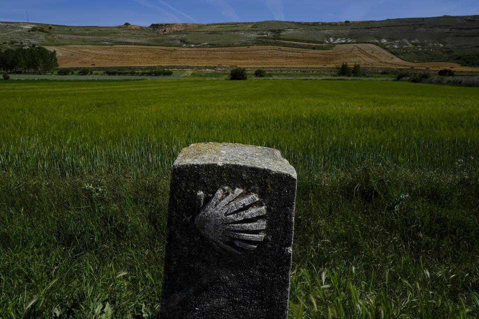 A view of el "Camino de Santiago" or St. James Way, near to Castrojeriz, northern Spain, Wednesday, June 1, 2022. Over centuries, villages with magnificent artwork were built along the Camino de Santiago, a 500-mile pilgrimage route crossing Spain. Today, Camino travelers are saving those towns from disappearing, rescuing the economy and vitality of hamlets that were steadily losing jobs and population. “The Camino is life,” say villagers along the route. (AP Photo/Alvaro Barrientos)