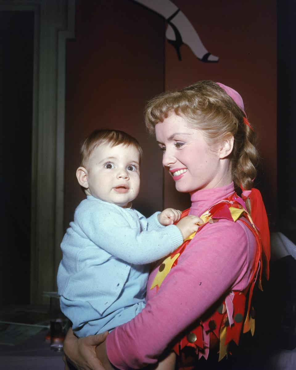 Reynolds holds her infant daughter.