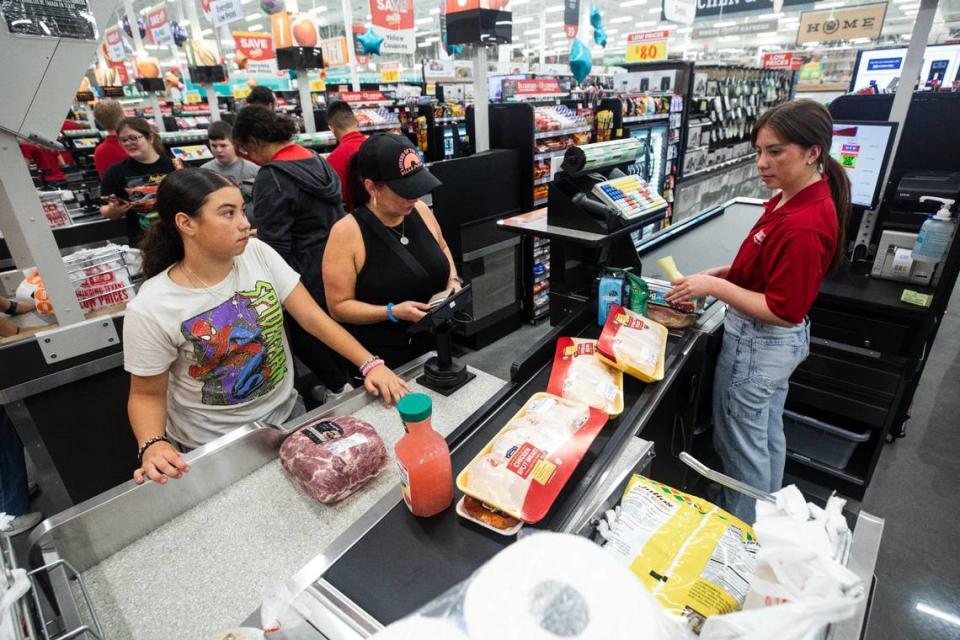 Shoppers stand at the checkout area during the grand opening of HEB on Wednesday, June 26 in Mansfield. HEB offers a variety of food options and poses as an attraction to texans all over the state.