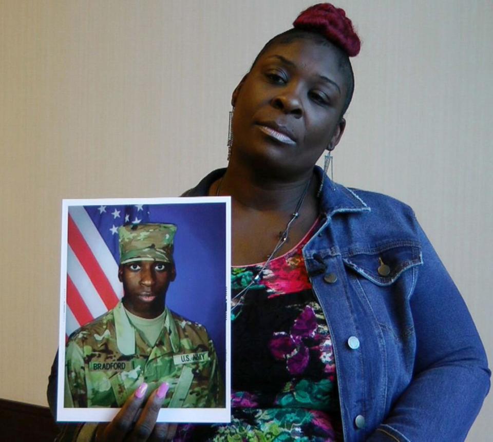 In this still image taken from video, April Pipkins holds a photograph of her deceased son, Emantic "EJ" Bradford Jr. Bradford was shot to death by a police officer in a shopping mall on Thanksgiving night.