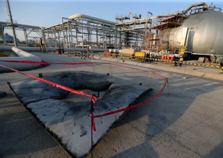 A metal part of a damaged tank is seen at the damaged site of Saudi Aramco oil facility in Abqaiq
