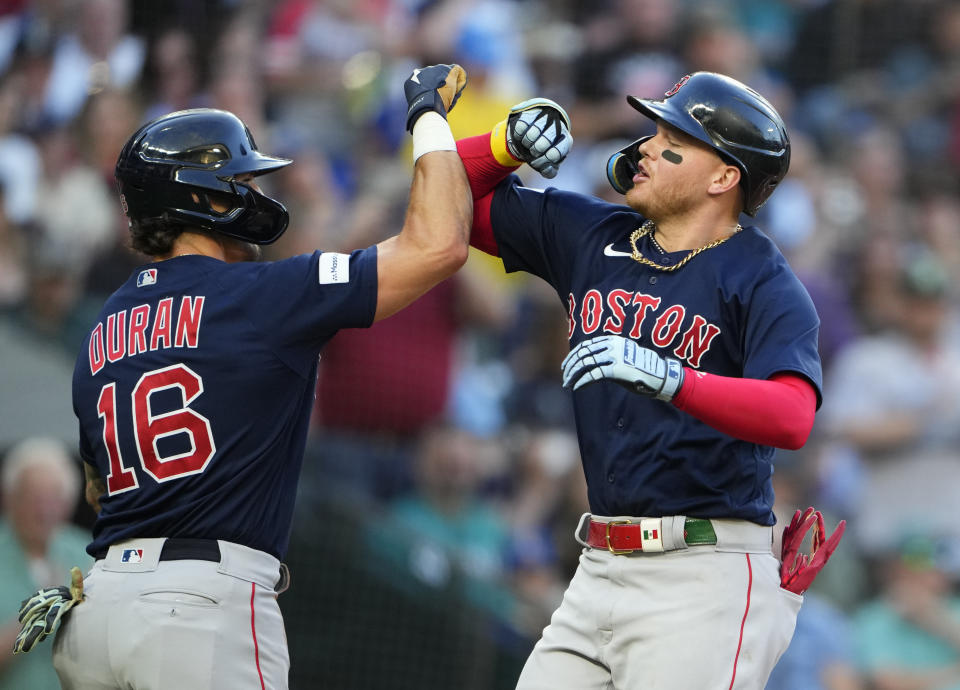 Boston Red Sox's Jarren Duran (16) greets Alex Verdugo, right, after he scored on Vertigo's two-run home run against the Seattle Mariners during the fifth inning of a baseball game, Tuesday, Aug. 1, 2023, in Seattle. (AP Photo/Lindsey Wasson)