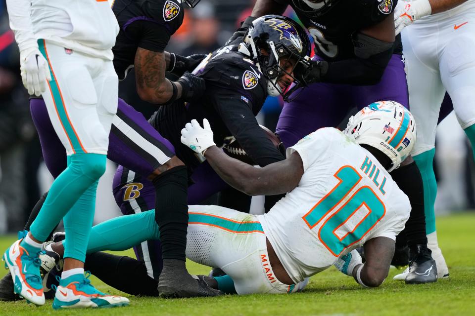 Baltimore Ravens safety Geno Stone (26) gets up after intercepting a pass intended for Miami Dolphins wide receiver Tyreek Hill (10) during the second half of an NFL football game in Baltimore, Sunday, Dec. 31, 2023. (AP Photo/Matt Rourke)