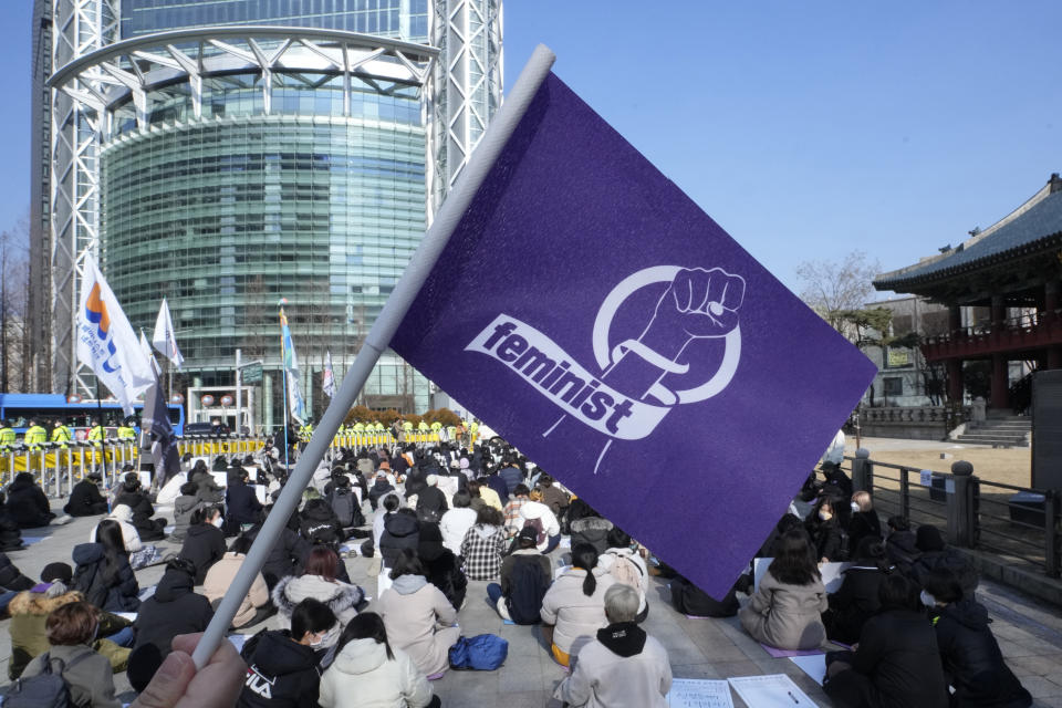 People stage a rally supporting feminism in Seoul, South Korea, Feb. 12, 2022. For years, the story of South Korean women has been defined by perseverance as they made gradual but steady progress in the workplace and fought against a deeply entrenched culture of misogyny and harassment. (AP Photo/Ahn Young-joon)