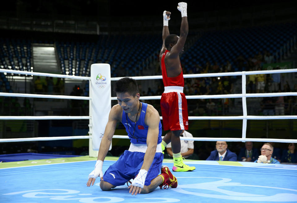 <p>Lv Bin of China reacts after losing the bout to Peter Mungai Warui of Kenya during the men’s light fly (49kg) round of 32 at the Rio Olympics on August 8, 2016. (REUTERS/Peter Cziborra) </p>