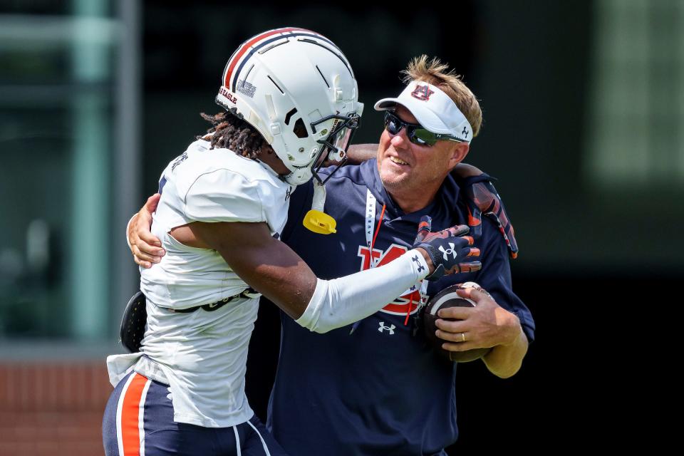 Auburn defensive back Jaylin Simpson (36) and coach Hugh Freeze during practice at the Woltosz Football Performance Center on Aug. 3, 2023.