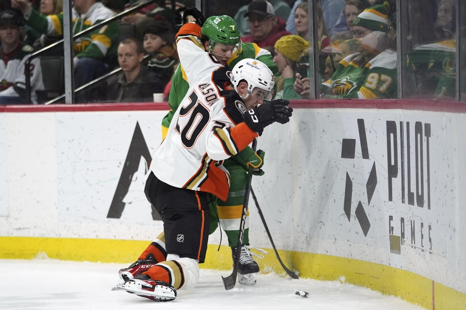 Anaheim Ducks right wing Brett Leason (20) and Minnesota Wild defenseman Brock Faber battle for the puck during the second period of an NHL hockey game Saturday, Jan. 27, 2024, in St. Paul, Minn. (AP Photo/Abbie Parr)