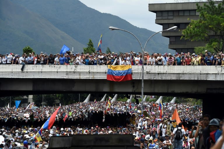 Demonstrators clash with riot police as they march along a major highway of Caracas during a protest against Venezuelan President Nicolas Maduro, on May 3, 2017