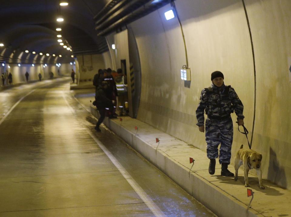 Russian police inspect a tunnel on the road between and Krasnaya as increased security measures are put into place ahead of the 2014 Winter Olympics, Thursday, Jan. 30, 2014, in Krasnaya Polyana, Russia. Outdor snow sports and sliding track events will take place in Krasnaya Polyana. (AP Photo/Luca Bruno)