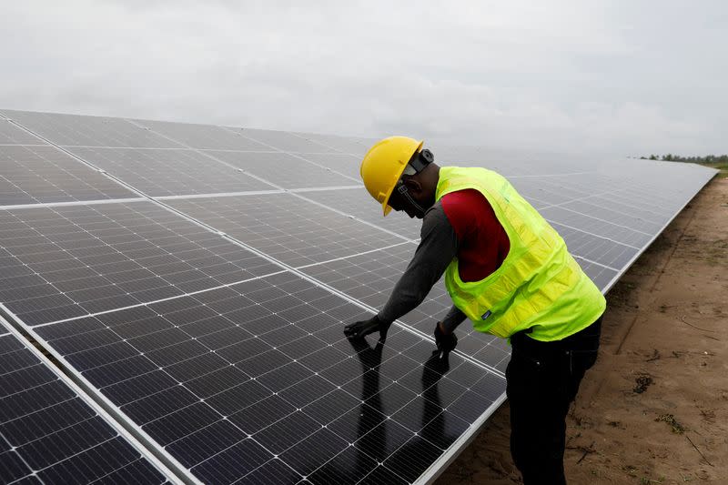 FILE PHOTO: A Technician works on solar power panels at the Atlantic Shrimpers farm in Badagry, Lagos