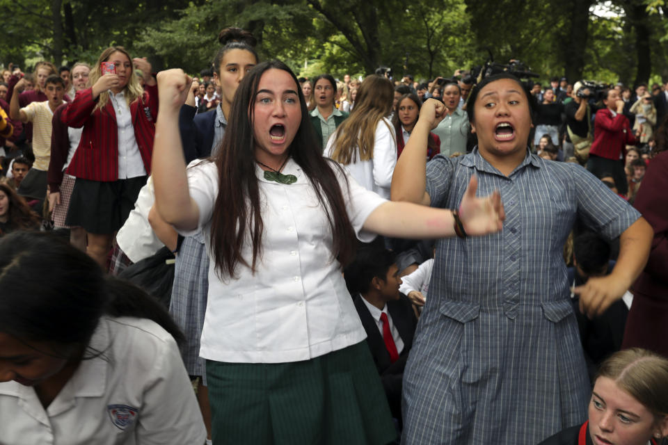 FILE - In this March 18, 2019, file photo, students perform the Haka during a vigil to commemorate victims of Friday's shooting, outside the Al Noor mosque in Christchurch, New Zealand. Day after day, the students of Christchurch have gathered, feet smashing the ground in unison as they chant the words of their nation's indigenous people in an outpouring of grief and love and support. In the aftermath of a white supremacist's deadly shooting spree on two mosques on March 15, the young people of Christchurch have found solace in an old tradition: a Maori ceremonial dance called the haka. (AP Photo/Vincent Thian, File)