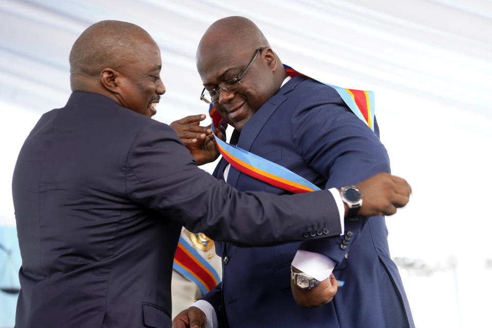 FILE - In this Thursday Jan. 24, 2019 file photo, Congolese President Felix Tshisekedi, right, receives the presidential sash from outgoing president Joseph Kabila after being sworn in in Kinshasa, Democratic Republic of the Congo. These African stories captured the world's attention in 2019 - and look to influence events on the continent in 2020. (AP Photo/Jerome Delay, File)