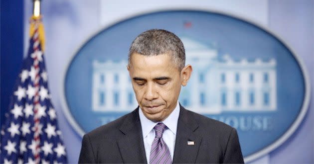 Barack Obama pauses and bows his head as he delivers a sombre tribute to Nelson Mandela from the White House in Washington. Photo: AAP